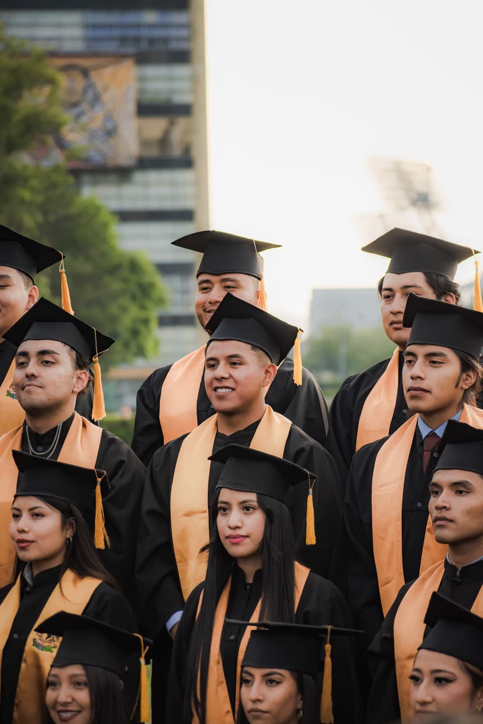 A diverse group of university graduates in caps and gowns